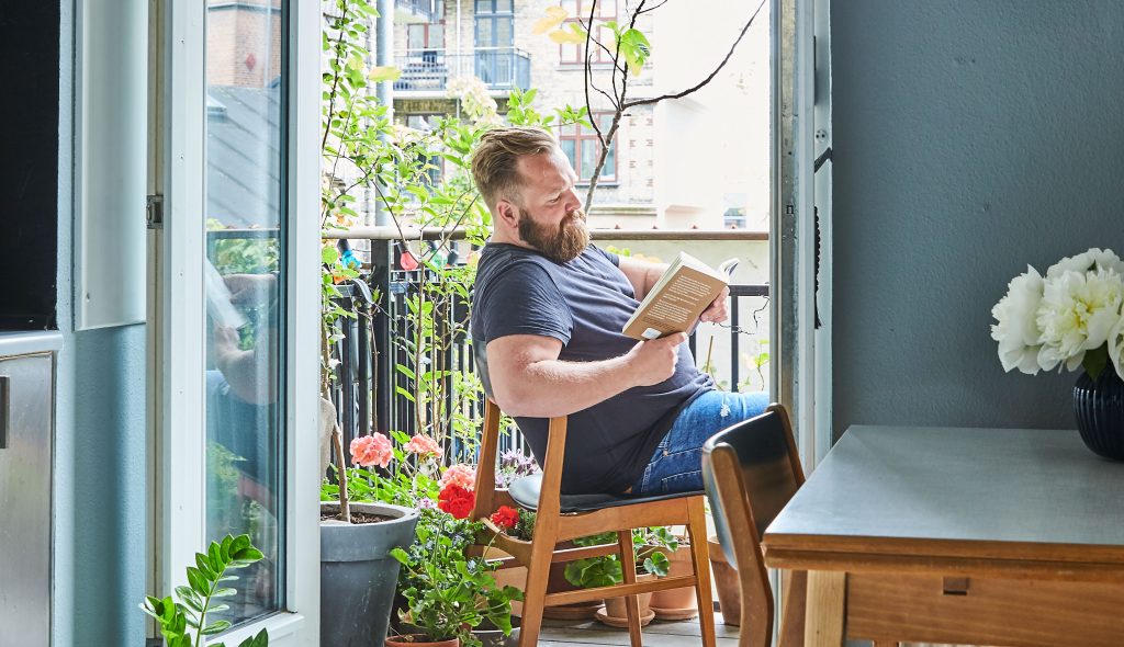 Lasse læser en bog på altanen
